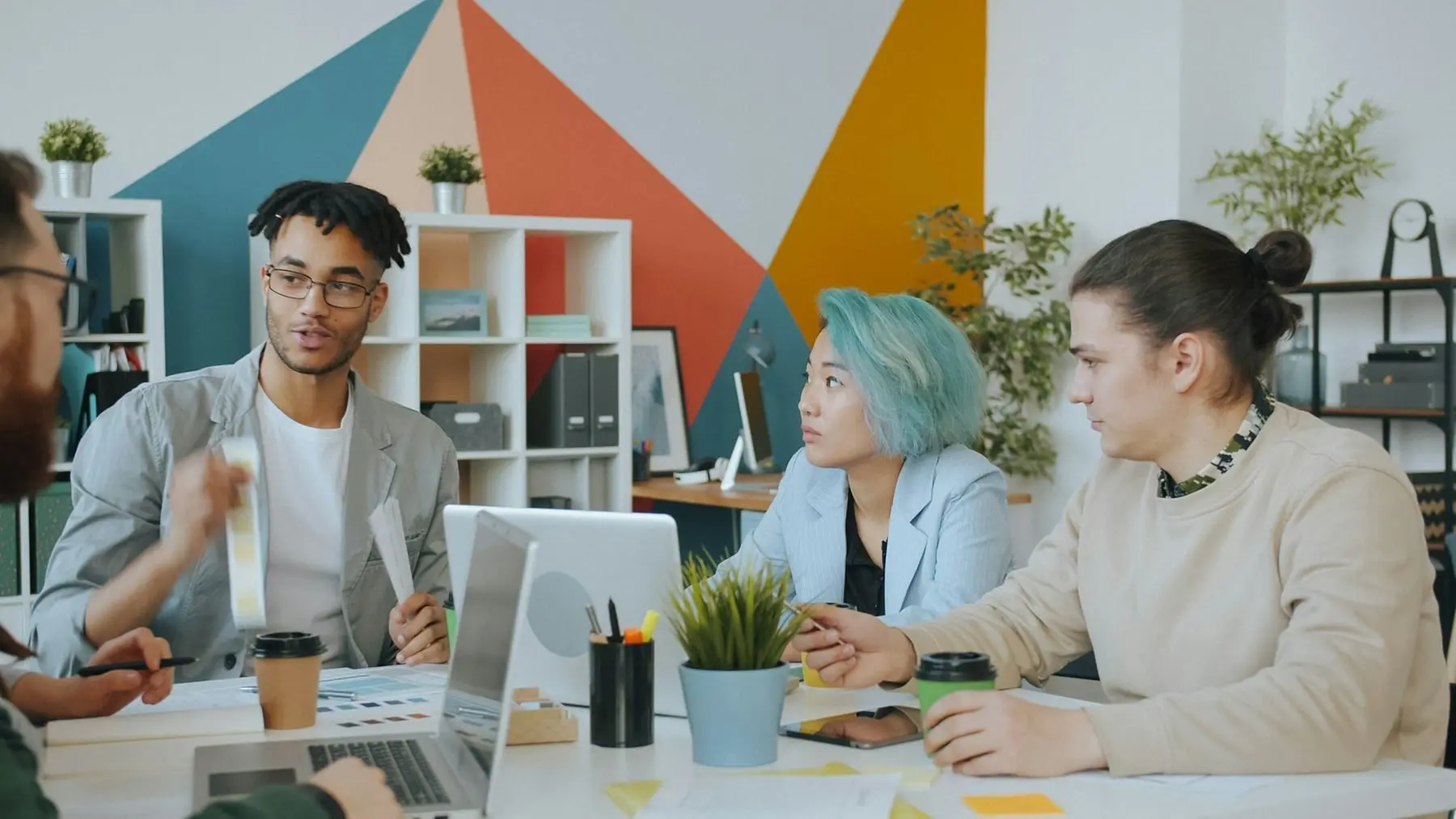 Marketing team collaborating around a table in a colorful studio